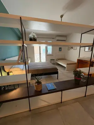 a room with two bunk beds and a bed at Nest - Family House in Santa Flavia