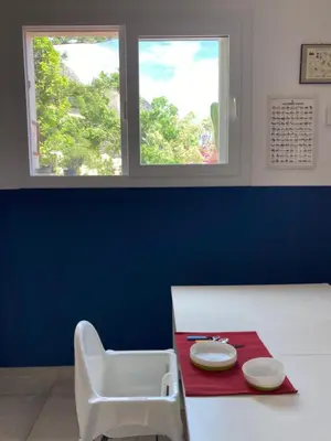 a room with a table with two plates on a red table at Nest - Family House in Santa Flavia