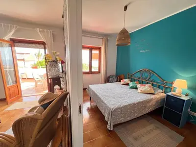 a bedroom with a bed and a blue wall at Orizzonte d'acqua Palermo in Palermo