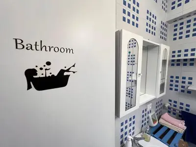 a bathroom with a person sitting in a bath tub sticker at Orizzonte d'acqua Palermo in Palermo