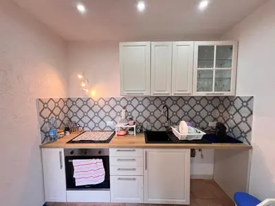 a kitchen with white cabinets and a counter top at Orizzonte d'acqua Palermo in Palermo