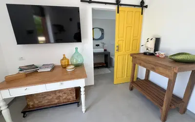 a room with a table and a yellow door at Rui2 Exclusive Accomodation in Terrasini