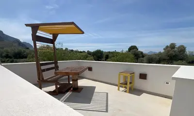 a wooden chair sitting on top of a roof at Rui2 Exclusive Accomodation in Terrasini