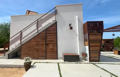 a building with a wooden door and a staircase at Rui2 Exclusive Accomodation in Terrasini