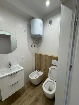 a white bathroom with a toilet and a sink at Asia Sicilian Home in Carini