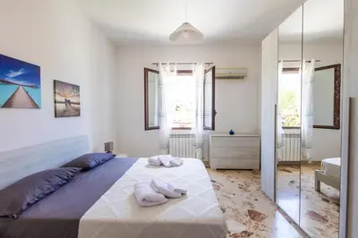 a bedroom with a large bed with towels on it at Casa Cloe Mondello in Palermo