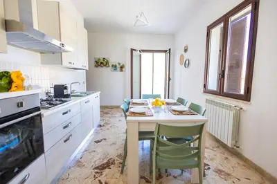 a kitchen with a table and chairs in a room at Casa Cloe Mondello in Palermo