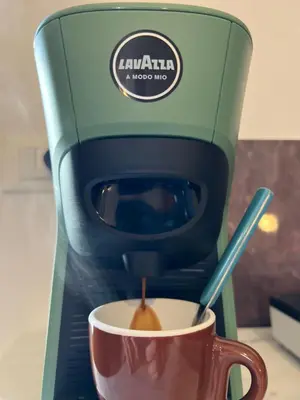 a coffee maker is making a cup of coffee at Casamori 3- nel cuore del mercato Ballarò in Palermo