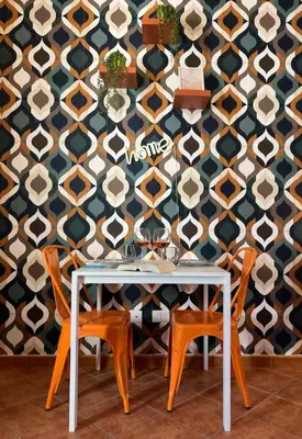 a dining room with a table and chairs in front of a wall at Casamori 3- nel cuore del mercato Ballarò in Palermo