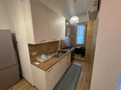 a kitchen with white cabinets and a sink at La Casa di Baloo in Palermo