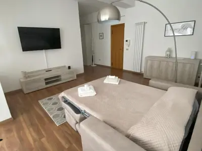a living room with a couch and a flat screen tv at La Casa di Baloo in Palermo
