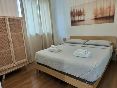 a white room with a bed and two windows at Maskan Palermo centro in Palermo