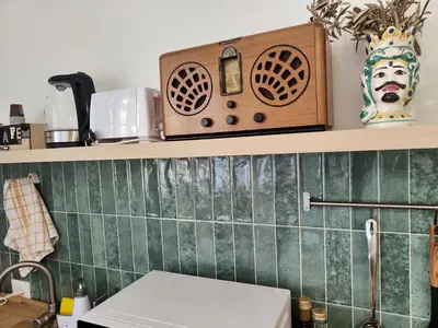 a kitchen with a sink and a counter with a microwave at Maskan Palermo centro in Palermo