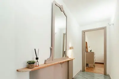 a mirror on a shelf in a hallway at Nuccia's home vacanze in natura in Ficarazzi