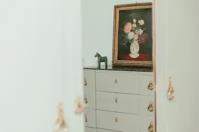 a painting of flowers in a vase on top of cabinets at Nuccia's home vacanze in natura in Ficarazzi