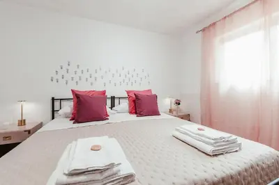 a bedroom with a large bed with towels on it at Nuccia's home vacanze in natura in Ficarazzi