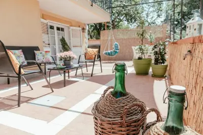 a patio with two bottles in a basket at Nuccia's home vacanze in natura in Ficarazzi