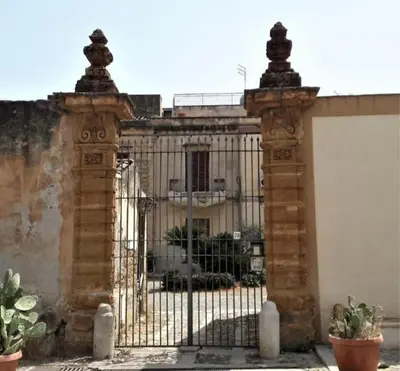 an iron gate in front of a building at Villetta Casaurro in Bagheria