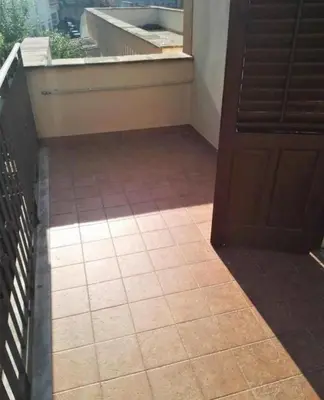 a room with a door and a tile floor at Villetta Casaurro in Bagheria