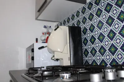 a mixer sitting on top of a stove in a kitchen at Agadir Apartment in Palermo