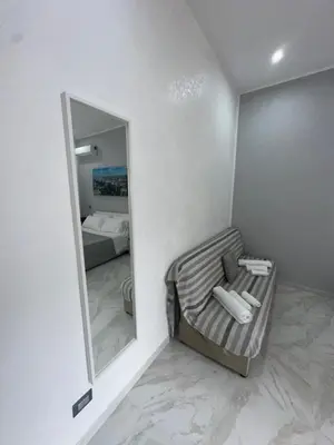 a room with a mirror and a bed in a room at Agadir Apartment in Palermo