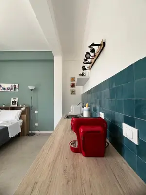 a red suitcase sitting on a wooden floor in a room at Al Tribunale Guest House in Palermo