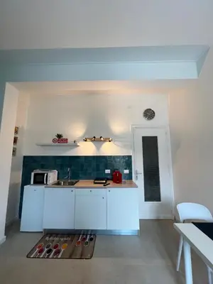a kitchen with white cabinets and a counter top at Al Tribunale Guest House in Palermo