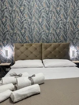 a bedroom with a bed with towels on it at Shama APARTMENTS in Palermo