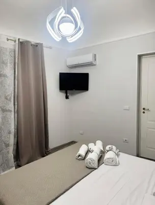 a bedroom with a bed with a tv on the wall at Shama APARTMENTS in Palermo