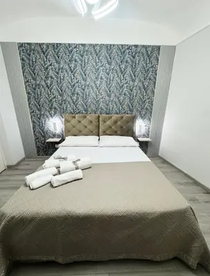 a bedroom with a large bed with towels on it at Shama APARTMENTS in Palermo