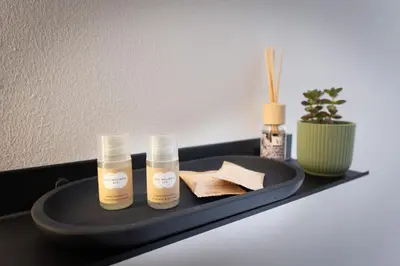 two bottles of moisturizers on a tray on a table at Gravina 75 Rooms in Palermo