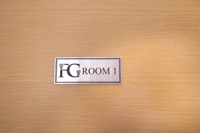 a sign on a wooden door with the word room at Gravina 75 Rooms in Palermo