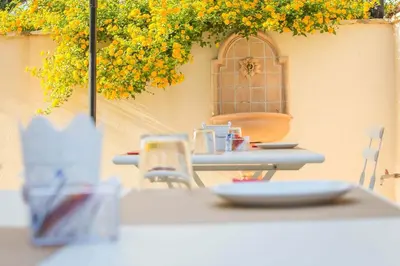 a table with a plate on top of it at Casale La Macina - Hotel, Scopello in Scopello