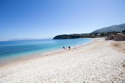 a group of people walking on a beach at Casale La Macina - Hotel, Scopello in Scopello