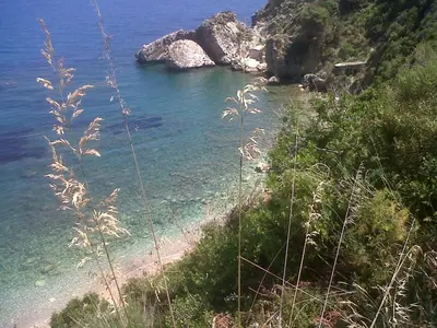 a view of a beach with rocks in the water at Casale La Macina - Hotel, Scopello in Scopello
