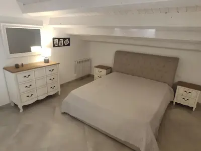 a bedroom with a bed and a dresser and a television at Central modern vacation home in Lascari - Casa Vacanze Luna in Lascari