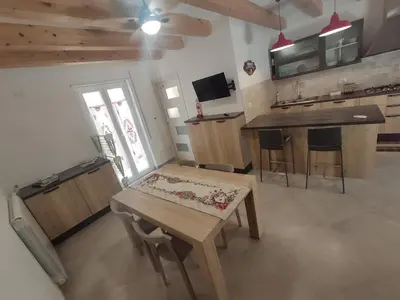a kitchen with a wooden table and a kitchen with a counter at Central modern vacation home in Lascari - Casa Vacanze Luna in Lascari