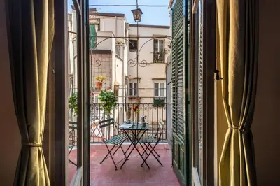 a view from a window of a balcony with a table at iFlat Suite del Barone with Terrace in Palermo
