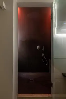 a bathroom with a shower stall with a hose at Vetro Apartments by Wonderful Italy in Palermo
