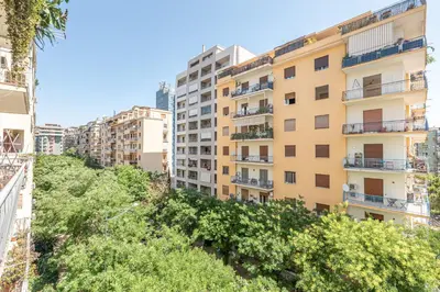 an apartment building in a city with trees at Vetro Apartments by Wonderful Italy in Palermo