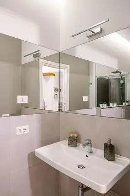 a bathroom with a sink and a mirror at Vittorio Maison - centro storico in Palermo