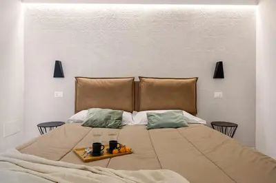 a bed with two drinks and a tray on it at Vittorio Maison - centro storico in Palermo