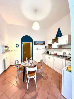 a kitchen and dining room with a table and chairs at La Loggia del Capo in Palermo