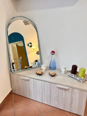a dressing table with a large mirror on top at La Loggia del Capo in Palermo