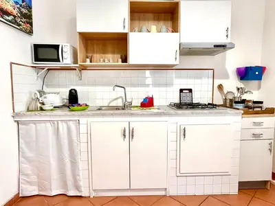 a kitchen with white cabinets and a sink at La Loggia del Capo in Palermo