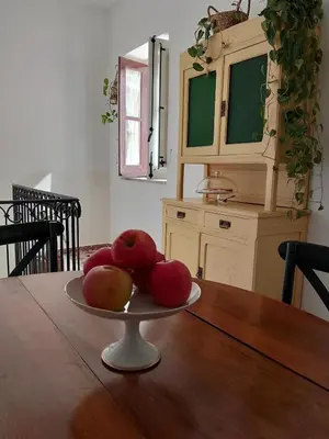 a plate of apples on a wooden table at Rooftop Magione in Palermo