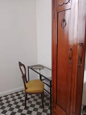a chair sitting next to a table and a desk at Rooftop Magione in Palermo