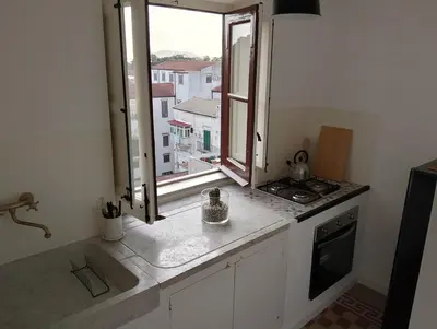 a kitchen with a window and a counter top at Rooftop Magione in Palermo