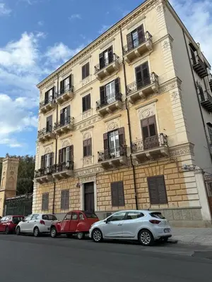 three cars parked in front of a building at Rooftop Magione in Palermo