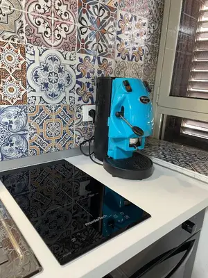 a blue sewing machine sitting on top of a counter at Vicolo Morici in Palermo